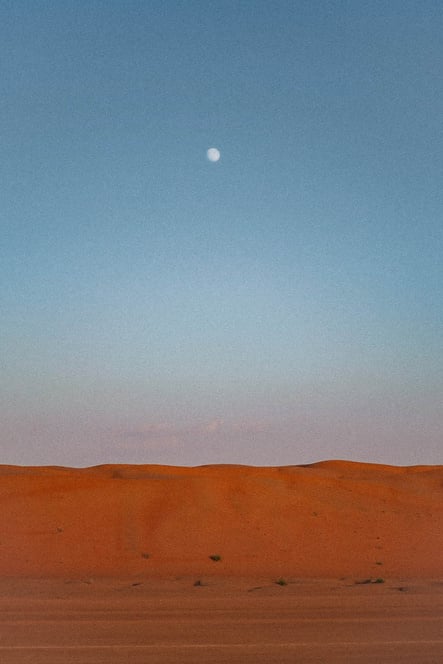 Moon Above the Mountain of Sand in a Desert